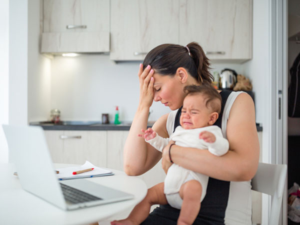 A new mother struggling with intrusive thoughts and anxiety — common signs of Postpartum OCD
