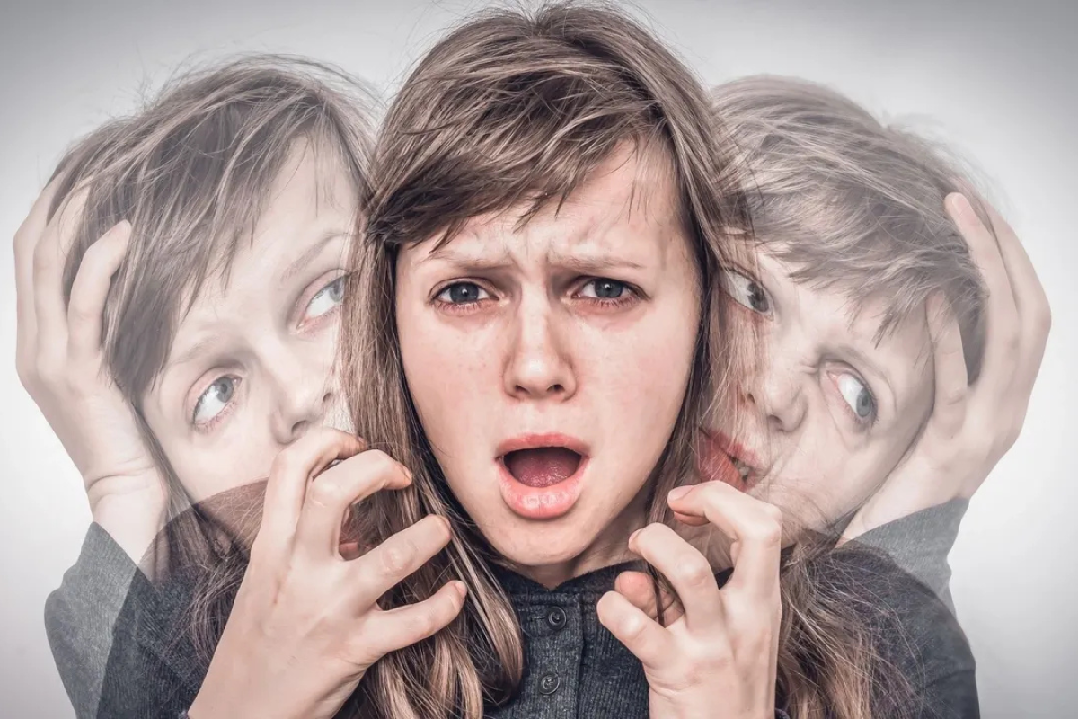 Anxious person struggling with intrusive violent thoughts, holding their head in distress.